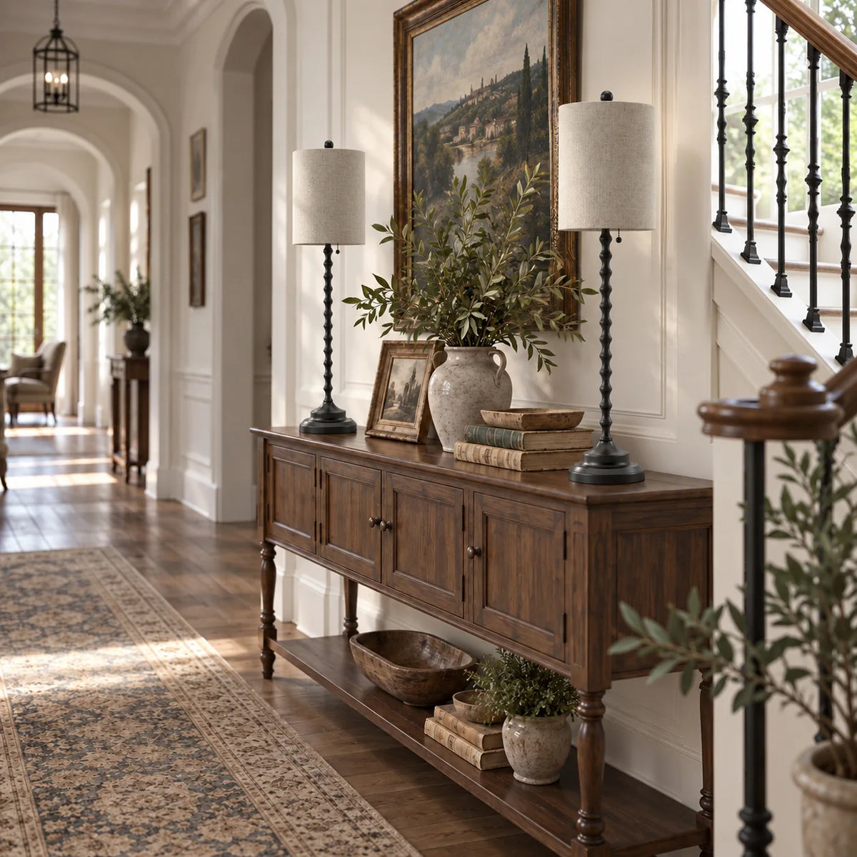 Two Lampworks black buffet lamps on a hallway console table beside a staircase
