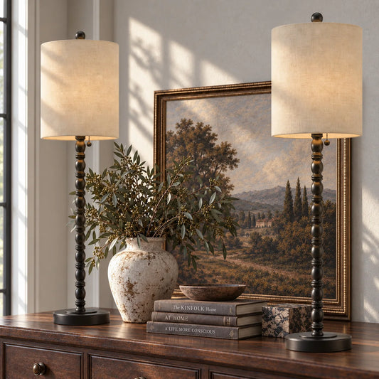 Lampworks matte black spindle buffet lamps set of two lit with a warm glow on a wood sideboard
