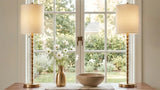 Pair of brass-look buffet lamps styled on a warm wood dining room sideboard