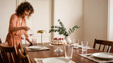 Rechargeable table lamp creating warm ambient light on a dining table