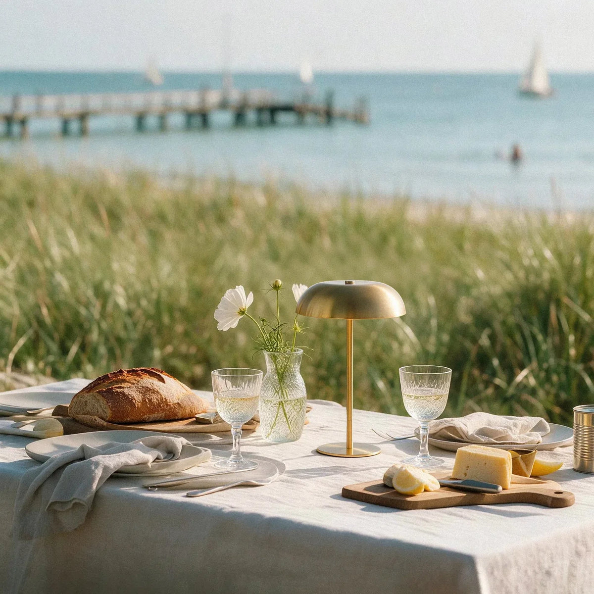 Brass cordless mushroom table lamp at a beach picnic