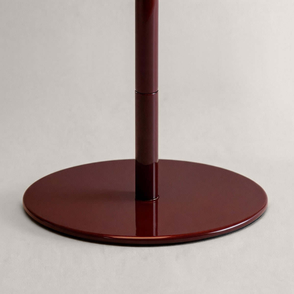Glossy oxblood cordless mushroom table lamp base and adjustable stem detail