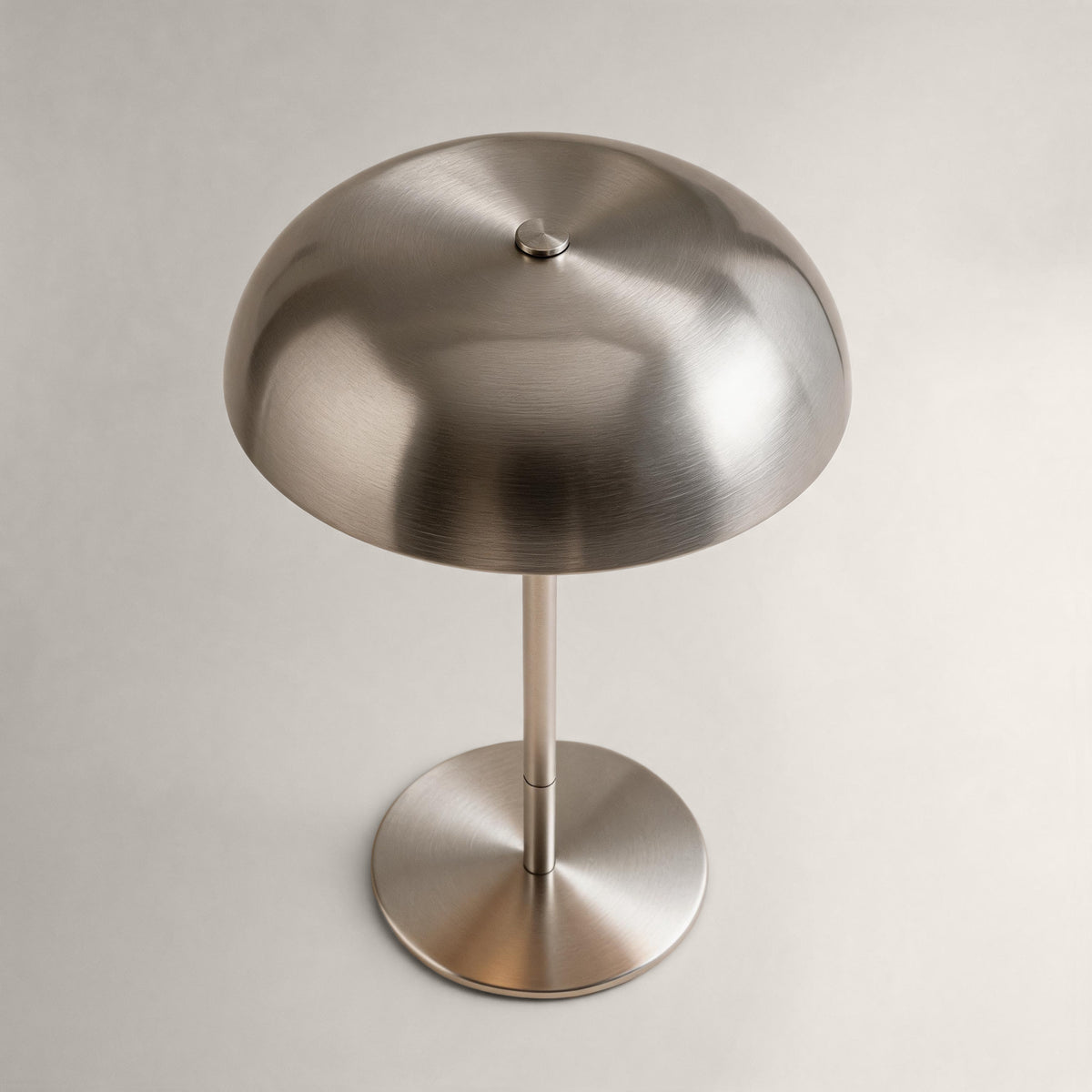 Brushed silver cordless mushroom table lamp shown from an elevated angle