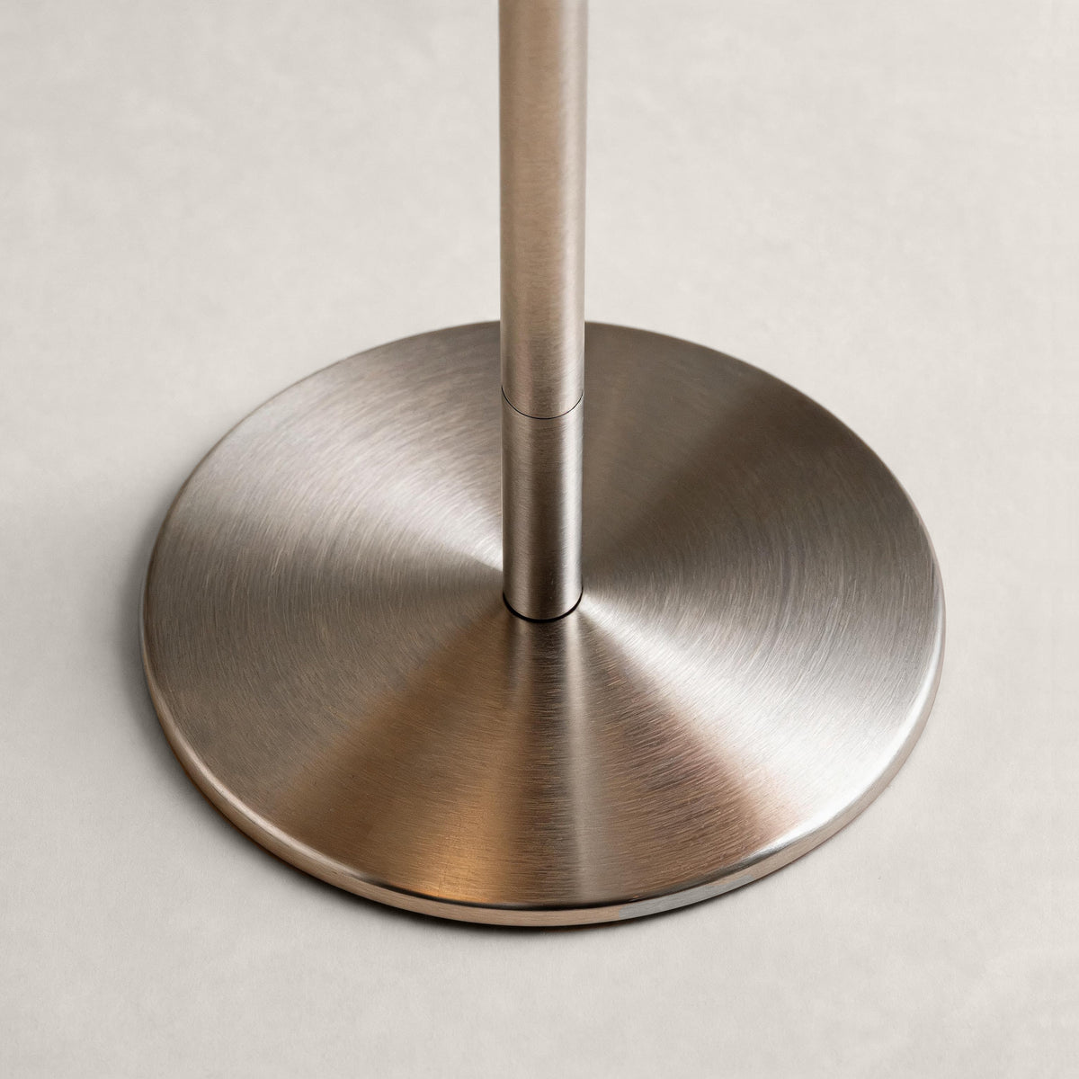 Brushed silver cordless mushroom table lamp base and adjustable stem detail