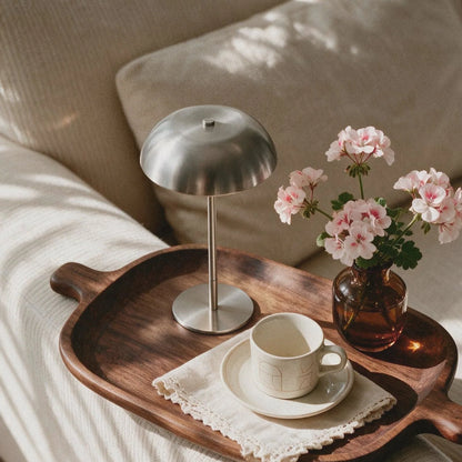 Brushed silver cordless mushroom table lamp styled on a wooden breakfast tray with flowers.