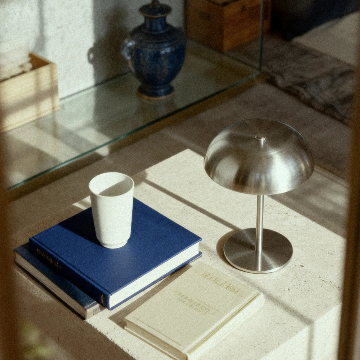 Silver cordless mushroom table lamp in a reading corner