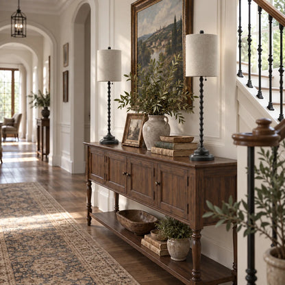 Two Lampworks black buffet lamps on a hallway console table beside a staircase