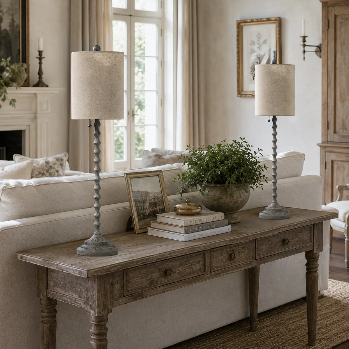 Lampworks weathered gray buffet lamps on a console table behind a living room sofa
