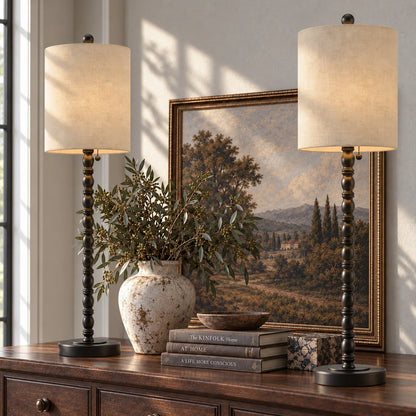 Lampworks matte black spindle buffet lamps set of two lit with a warm glow on a wood sideboard