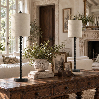 Lampworks matte black buffet lamps on a living room console table behind a sofa