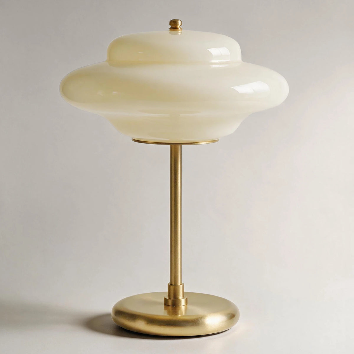 Lampworks glass table lamp with a milky white opal glass shade, brass-tone stem and round base