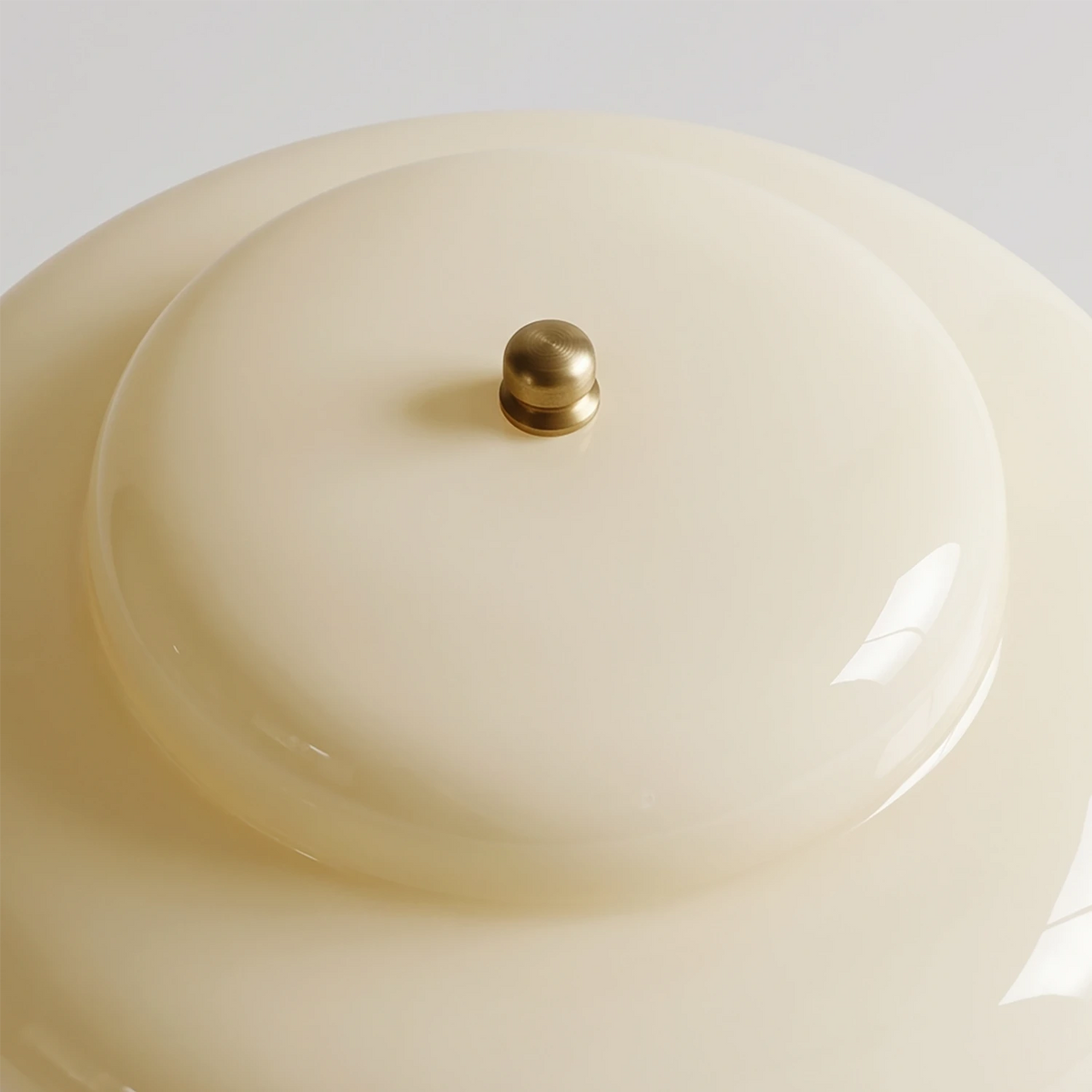 Top view of the Lampworks opal glass shade with a small brass-tone control at its center