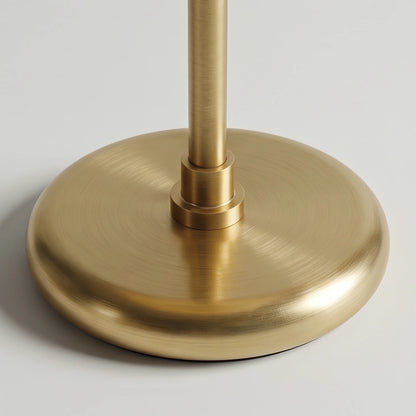 Close-up of the Lampworks glass table lamp's round brass-tone base and slender stem