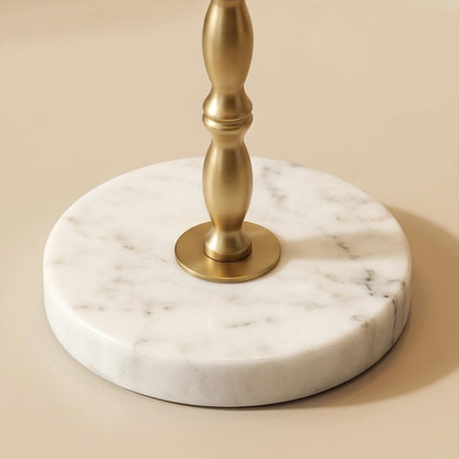 Close-up of the Noor buffet lamp's round white marble base with natural gray veining and brass stem.